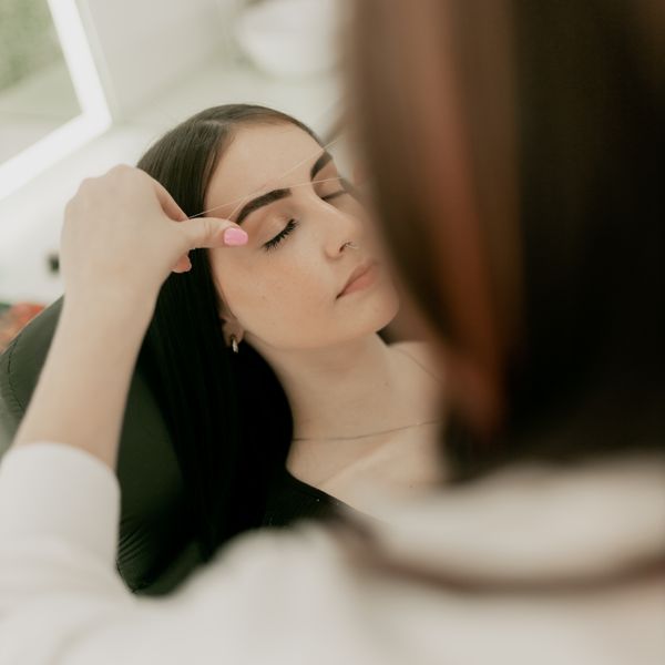 Brow shaping and tinting in progress at the studio