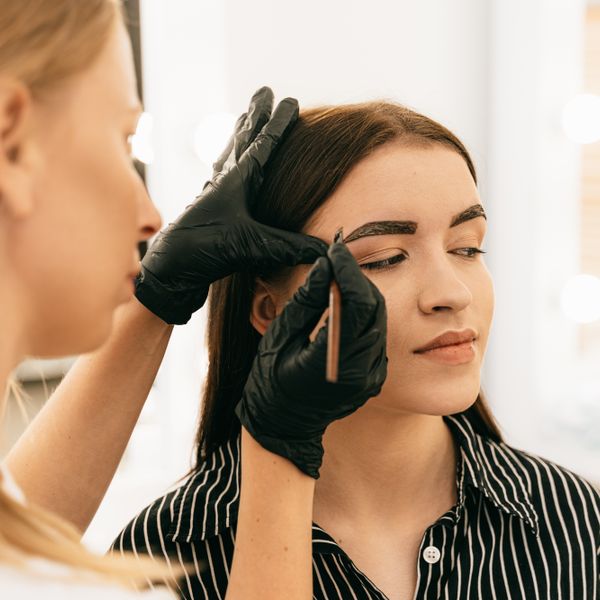 Brow lamination — brows being brushed and set