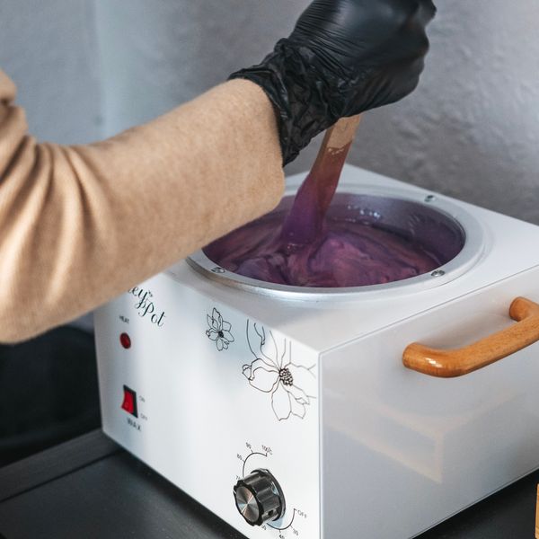 Warm wax being prepared in the studio wax pot